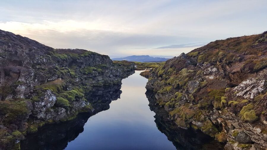 From Reykjavik: Silfra Snorkeling with Free Photos - The safety briefing and first minutes in the water