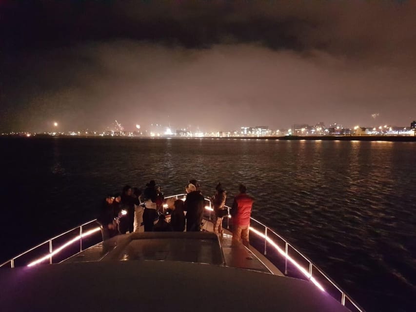 Reykjavík: New Year's Eve Northern Lights Yacht Cruise - Returning toward the shore for midnight fireworks